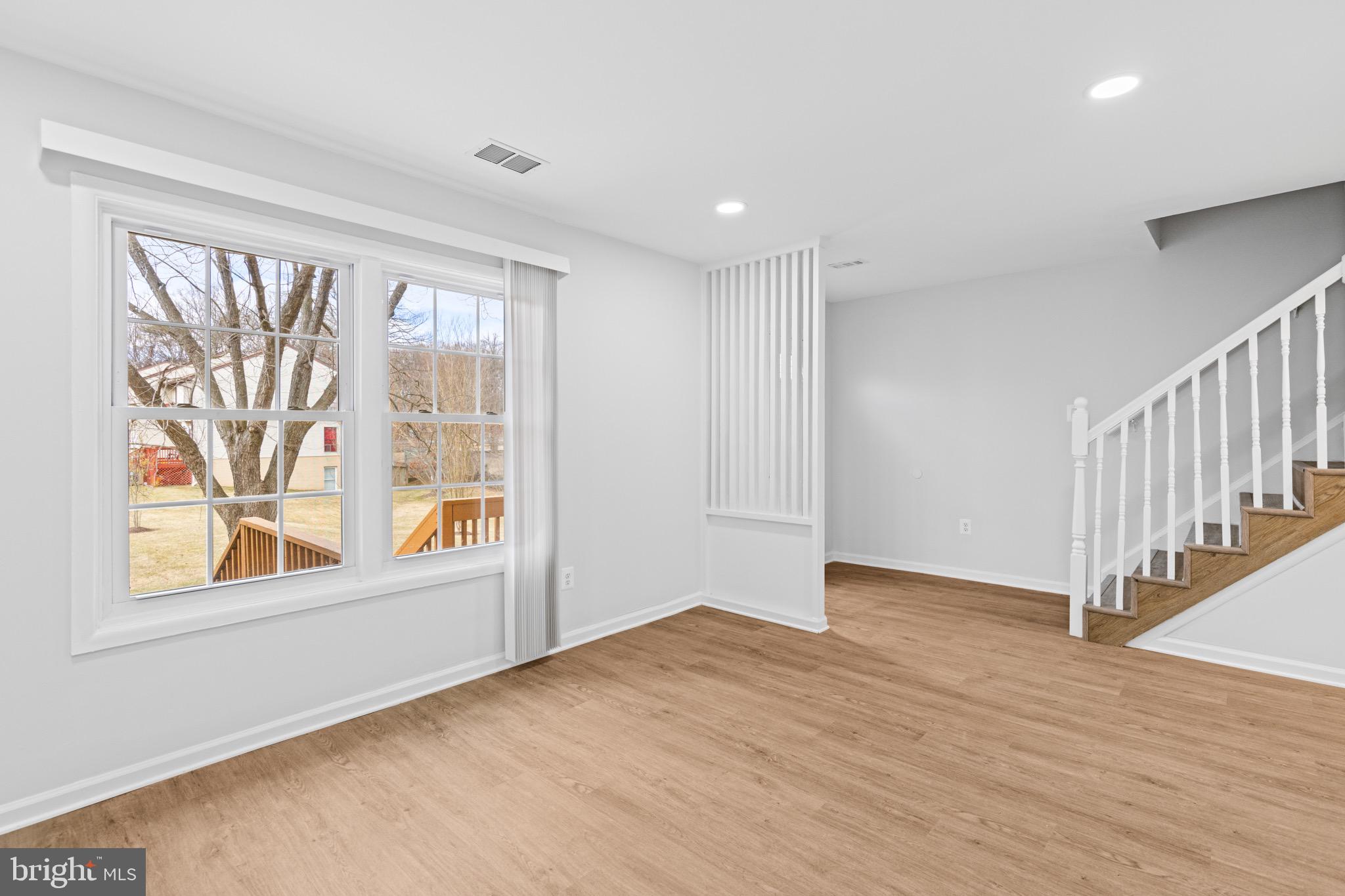 11474 Laurelwalk Drive Laurel, MD 20708 - Photo 7 of 22 a view of an empty room with a window and wooden floor