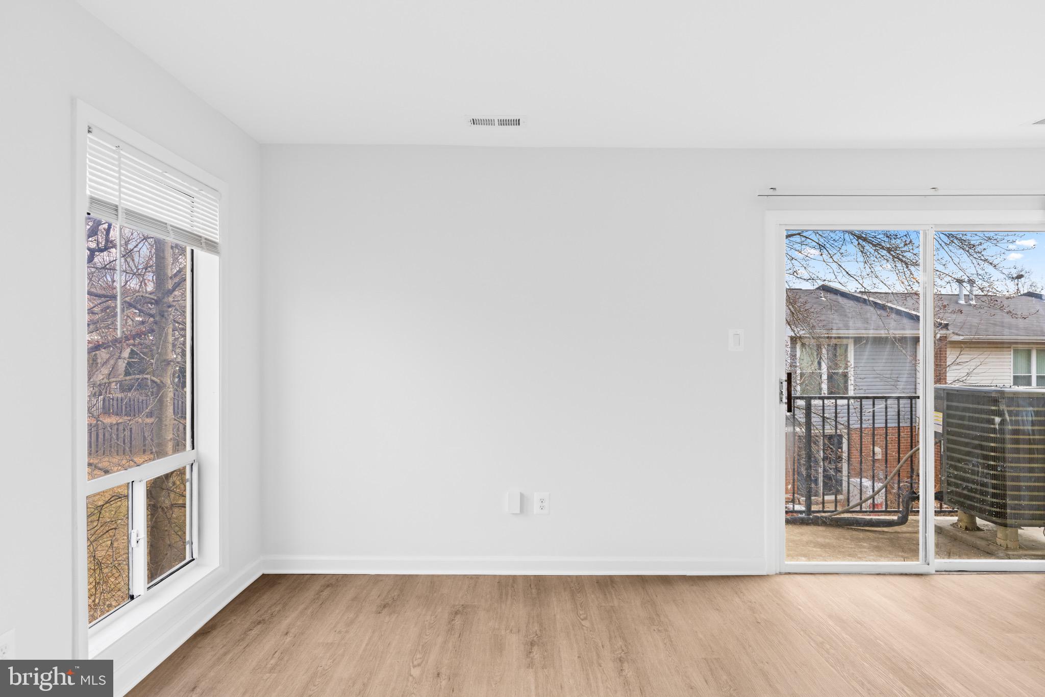 11474 Laurelwalk Drive Laurel, MD 20708 - Photo 9 of 22 a view of an empty room with wooden floor and a window
