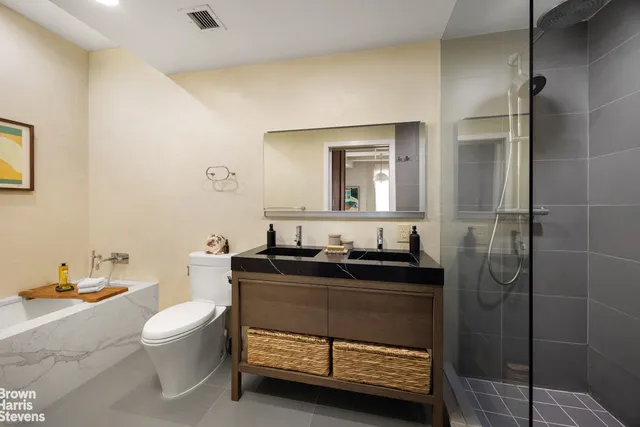 a bathroom with a granite countertop sink a toilet and a mirror