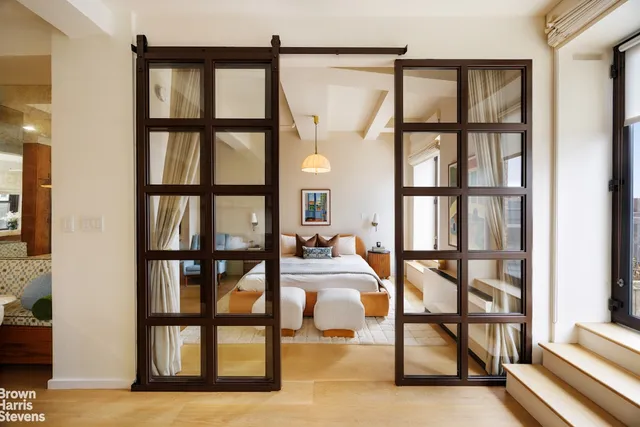 a living room with furniture and painting on the wall