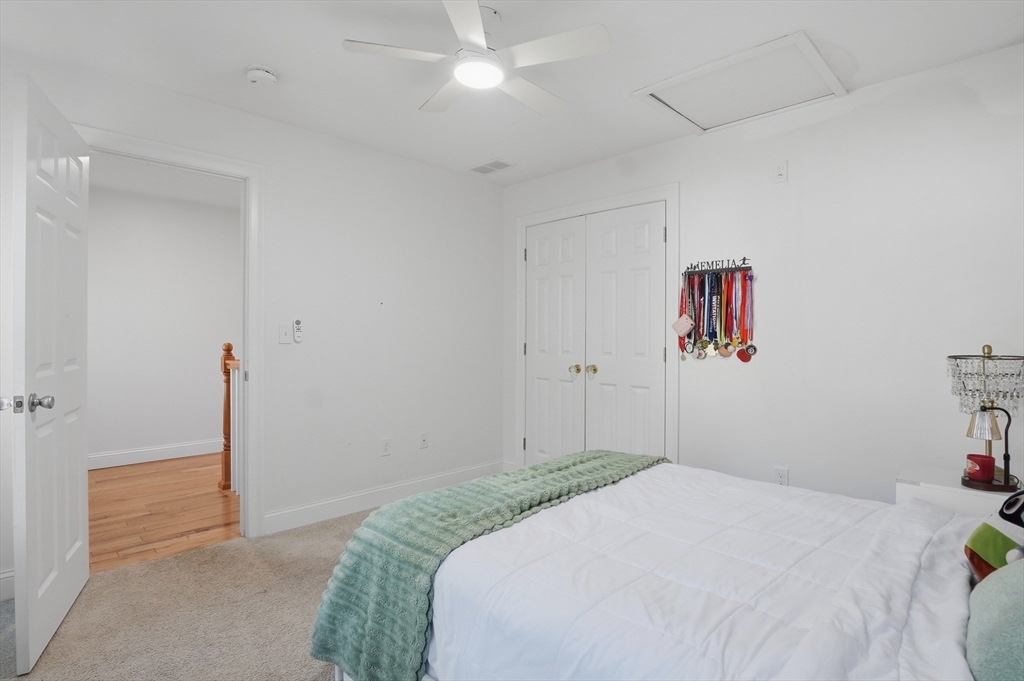 155 Turkey Hill Road Rutland, MA 01543 - Photo 14 of 38 a bedroom with a bed and a chandelier