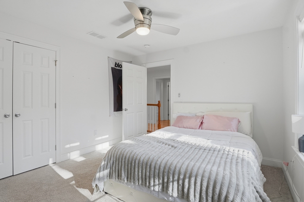 155 Turkey Hill Road Rutland, MA 01543 - Photo 18 of 38 a bedroom with a large bed and a chandelier