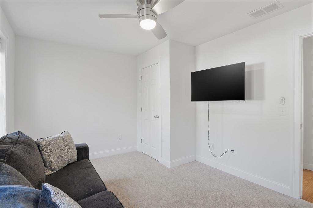 155 Turkey Hill Road Rutland, MA 01543 - Photo 20 of 38 a living room with furniture and a flat screen tv