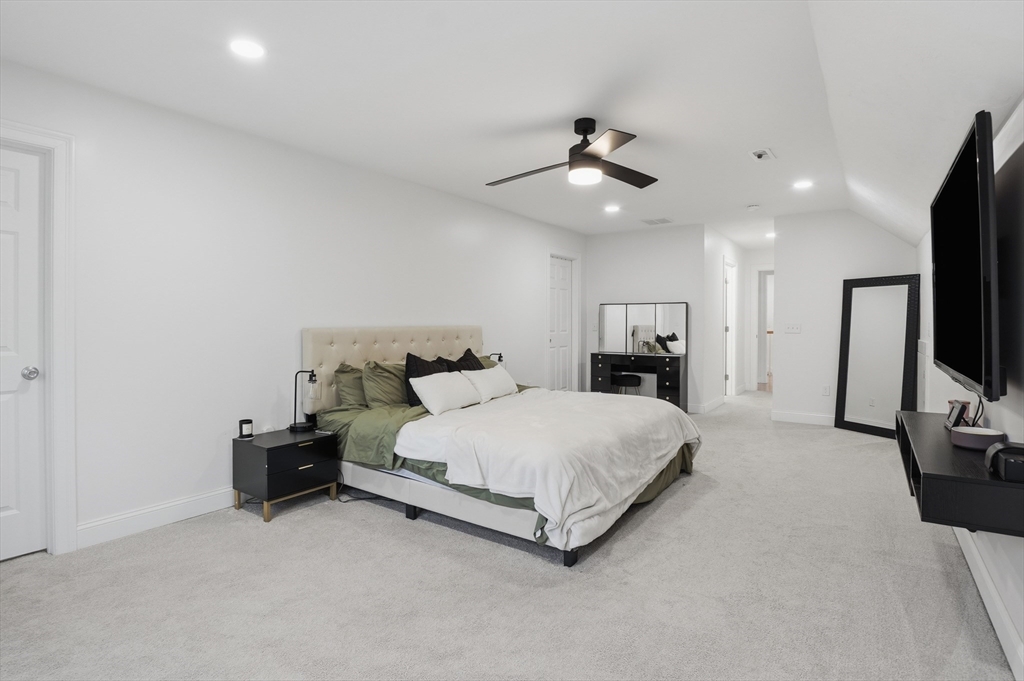 155 Turkey Hill Road Rutland, MA 01543 - Photo 21 of 38 a spacious bedroom with a bed and a flat tv screen on dresser