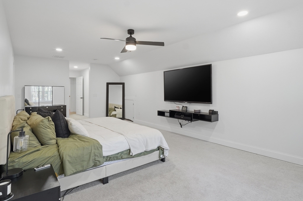 155 Turkey Hill Road Rutland, MA 01543 - Photo 24 of 38 a bedroom with a bed and a flat tv screen on wall