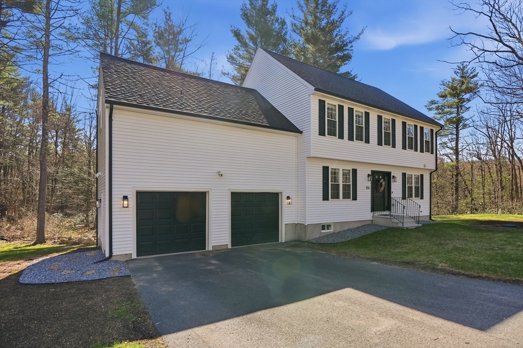 155 Turkey Hill Road Rutland, MA 01543 - Photo 33 of 38 a front view of a house with a yard and garage