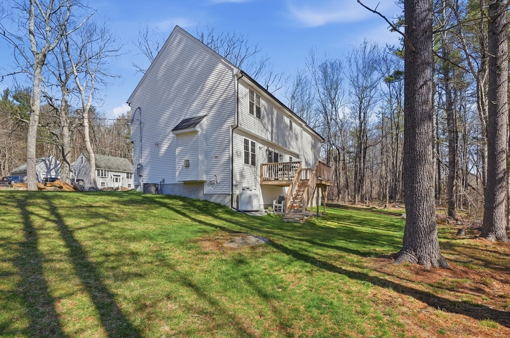 155 Turkey Hill Road Rutland, MA 01543 - Photo 37 of 38 a view of a house with a big yard and large trees