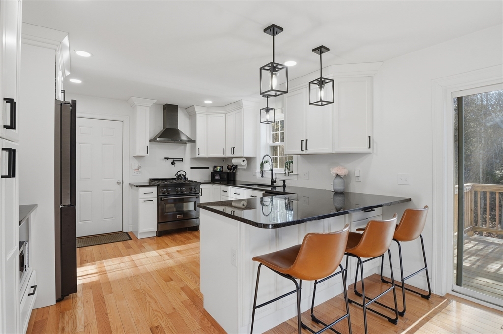 155 Turkey Hill Road Rutland, MA 01543 - Photo 5 of 38 a kitchen with stainless steel appliances granite countertop a sink a stove a refrigerator and island with wooden floor