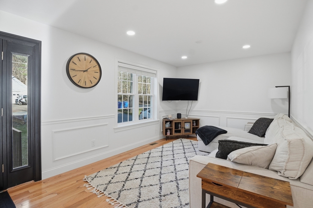 155 Turkey Hill Road Rutland, MA 01543 - Photo 9 of 38 a living room with furniture a clock and a flat screen tv