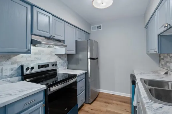 a kitchen with a stove and a refrigerator