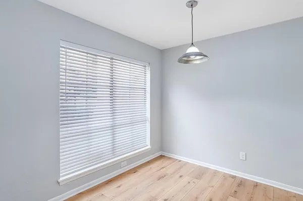a view of a room with a ceiling fan and window