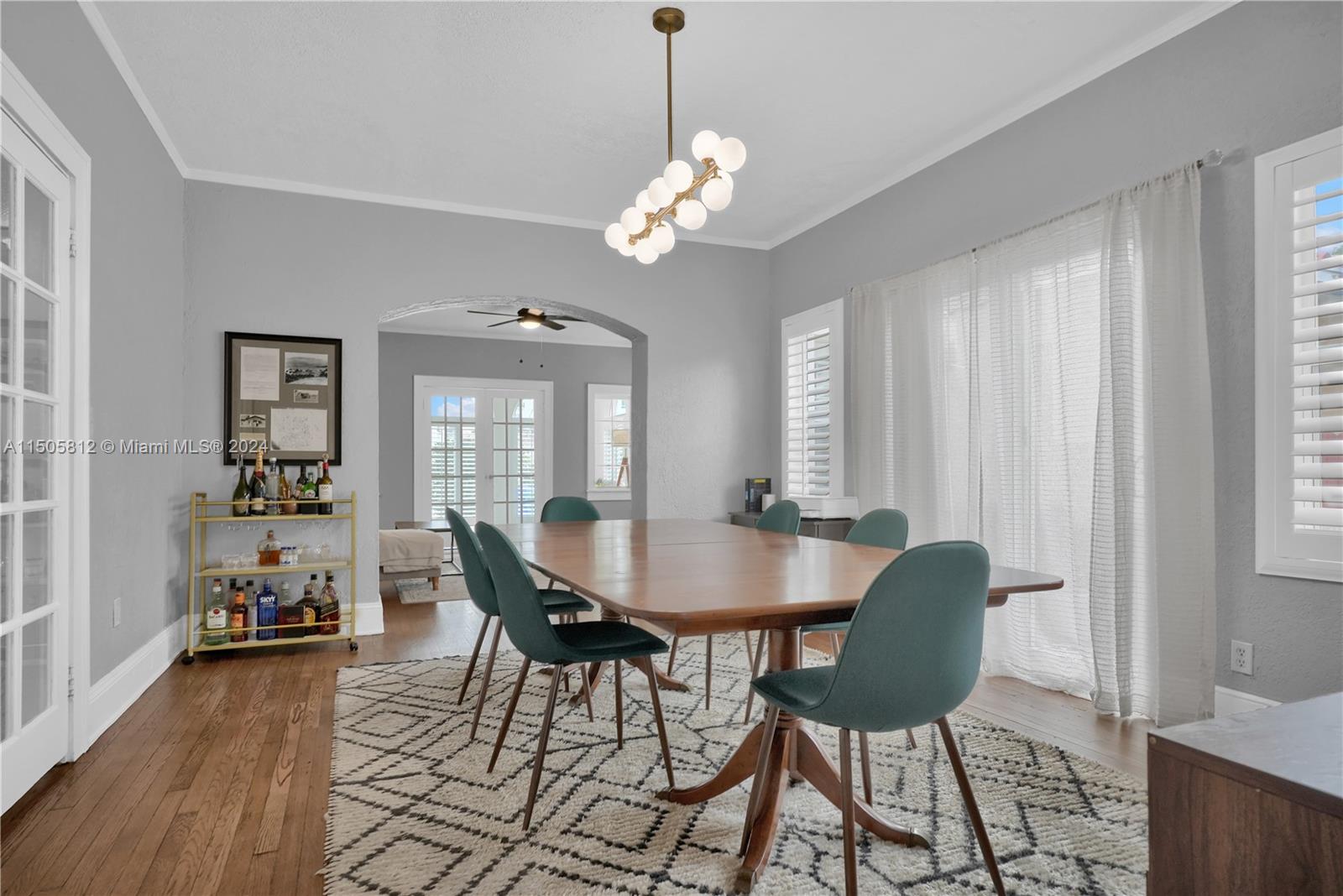2043 Southwest 7th Street Miami, FL 33135 - Photo 14 of 37 a dining room with furniture a chandelier and wooden floor