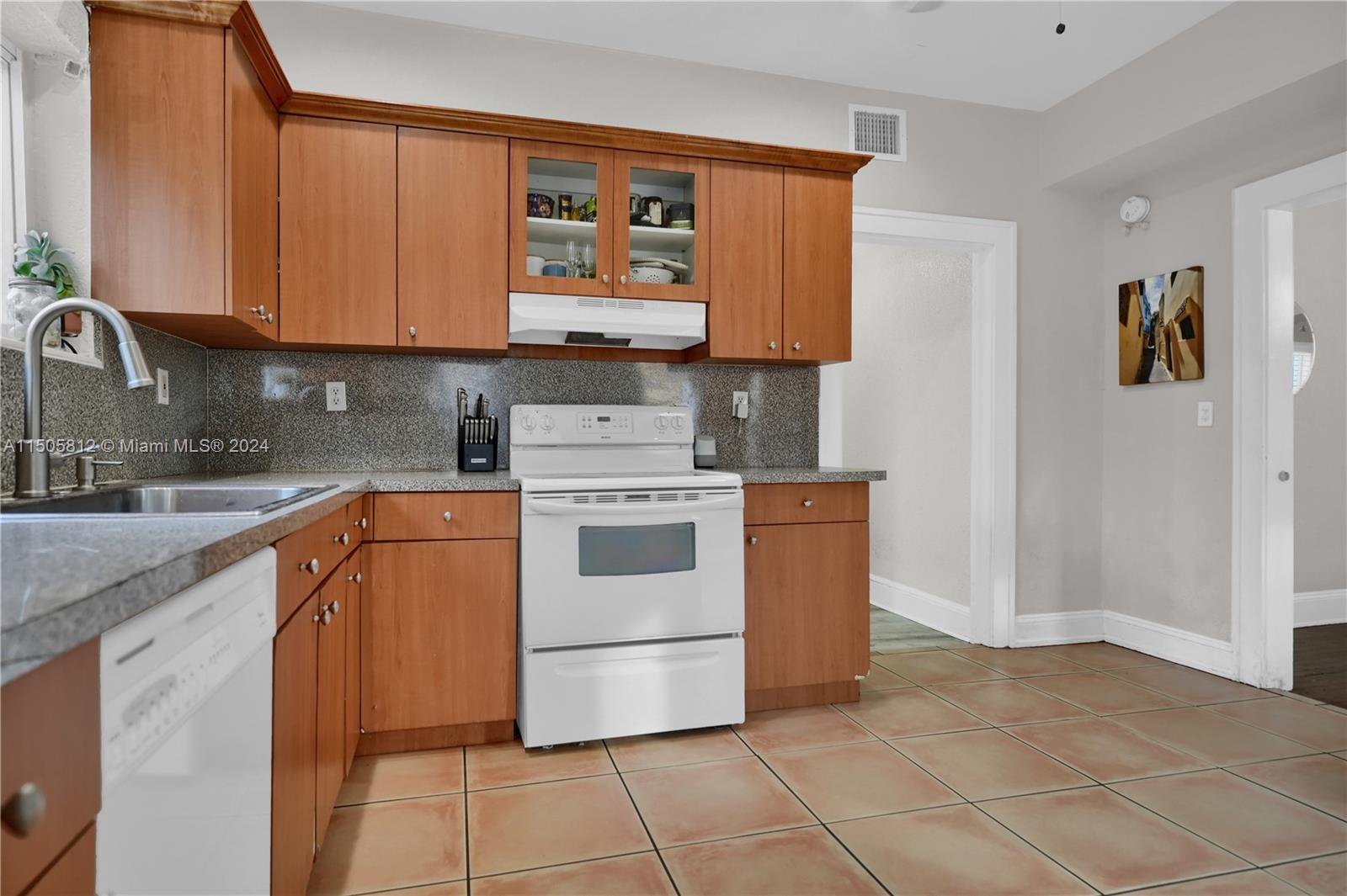 2043 Southwest 7th Street Miami, FL 33135 - Photo 16 of 37 a kitchen with stainless steel appliances granite countertop a stove a sink and a refrigerator