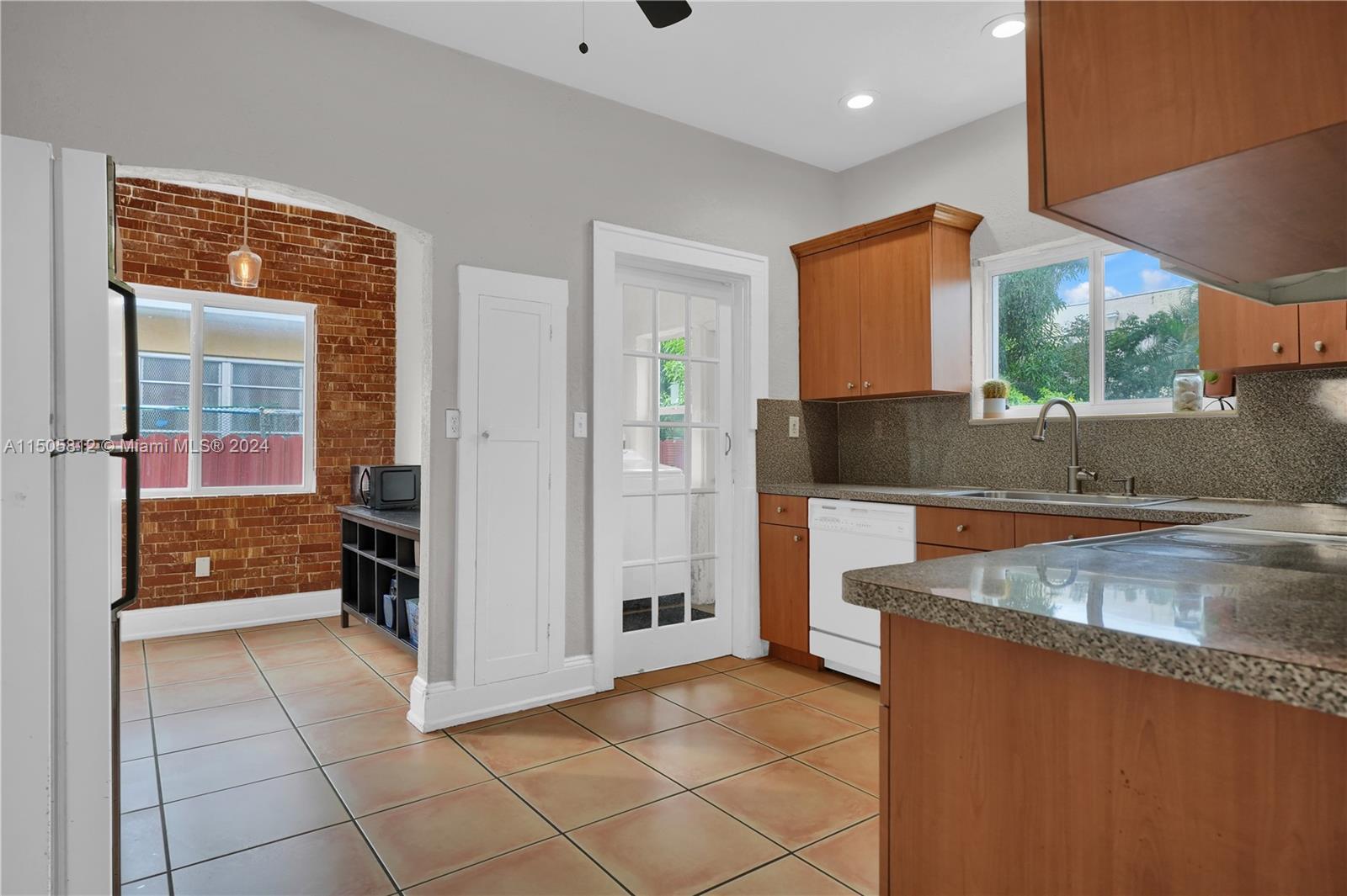 2043 Southwest 7th Street Miami, FL 33135 - Photo 17 of 37 a kitchen with stainless steel appliances granite countertop a refrigerator and a sink