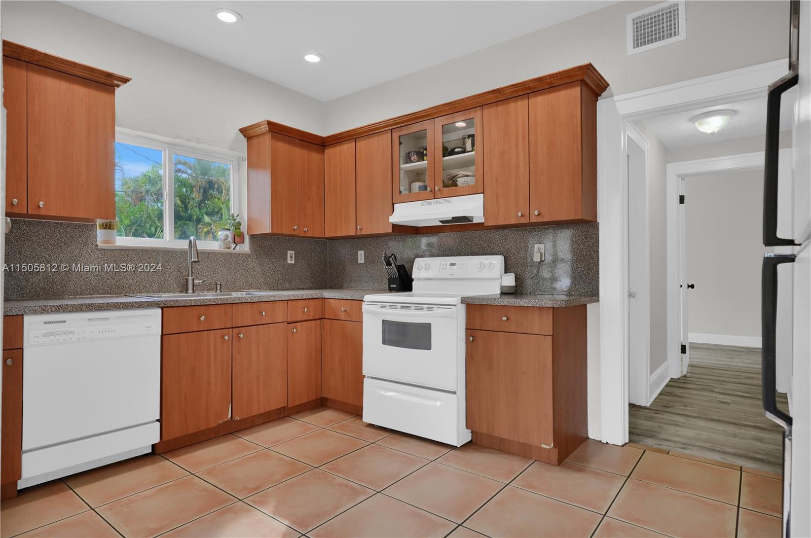 2043 Southwest 7th Street Miami, FL 33135 - Photo 18 of 37 a kitchen with stainless steel appliances granite countertop a stove a sink and a refrigerator