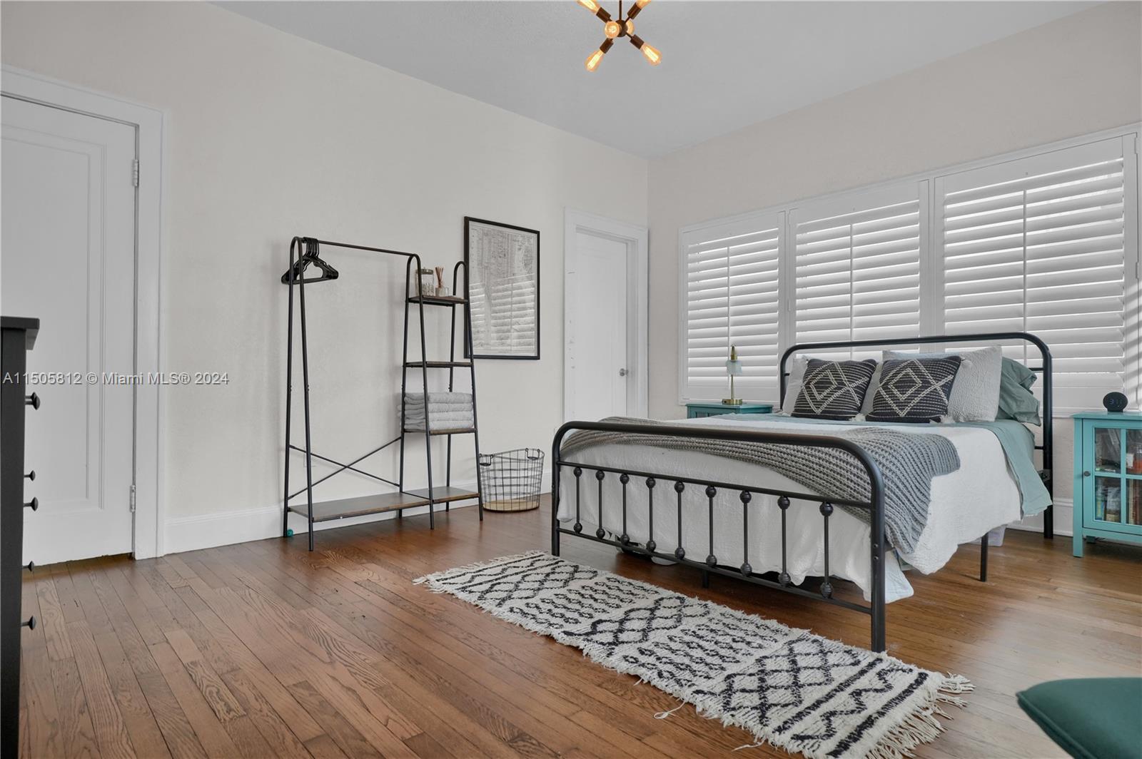 2043 Southwest 7th Street Miami, FL 33135 - Photo 22 of 37 a bedroom with a bed rug and wooden floor