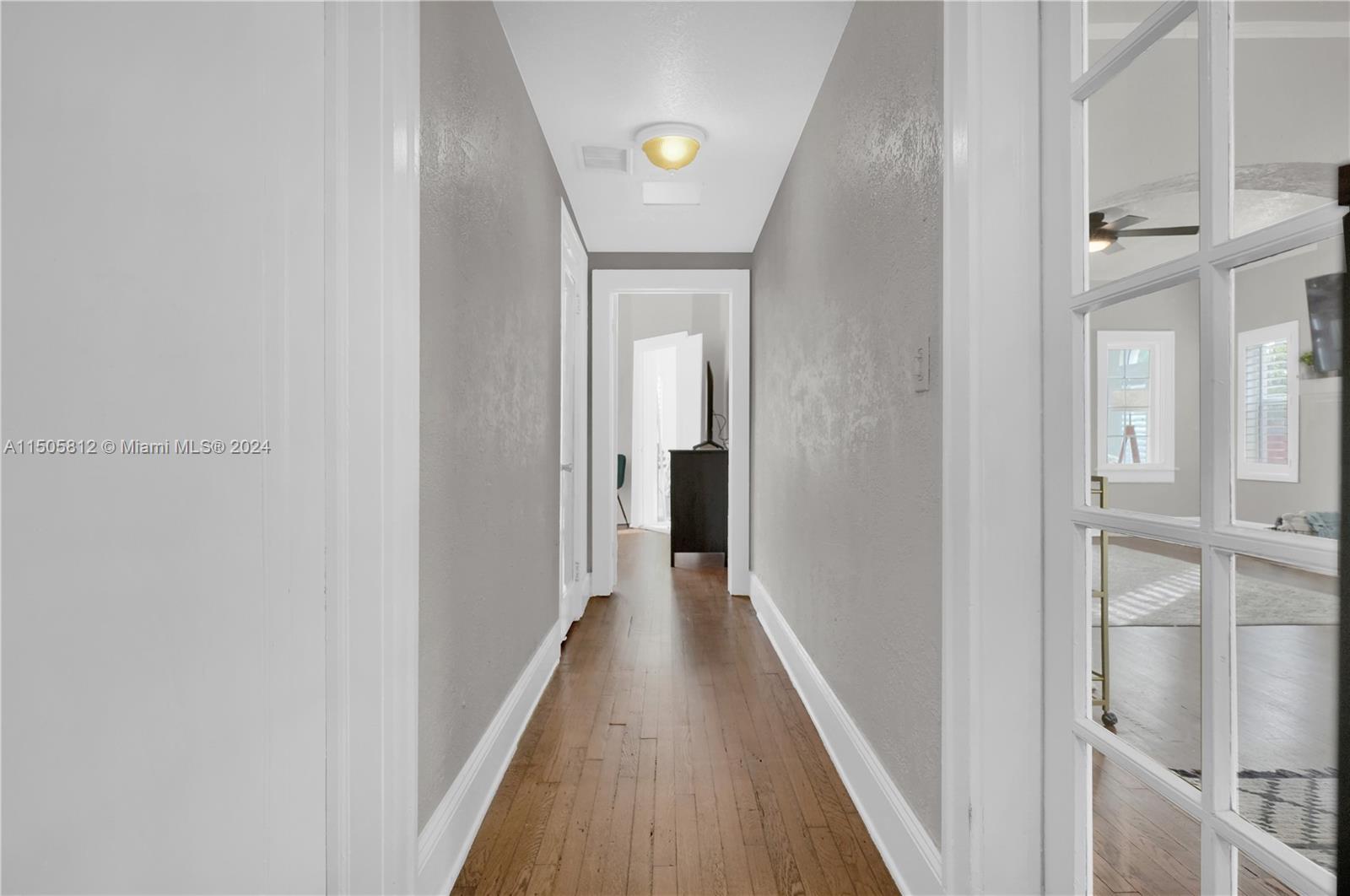 2043 Southwest 7th Street Miami, FL 33135 - Photo 23 of 37 a view of a hallway with wooden floor and a bathroom