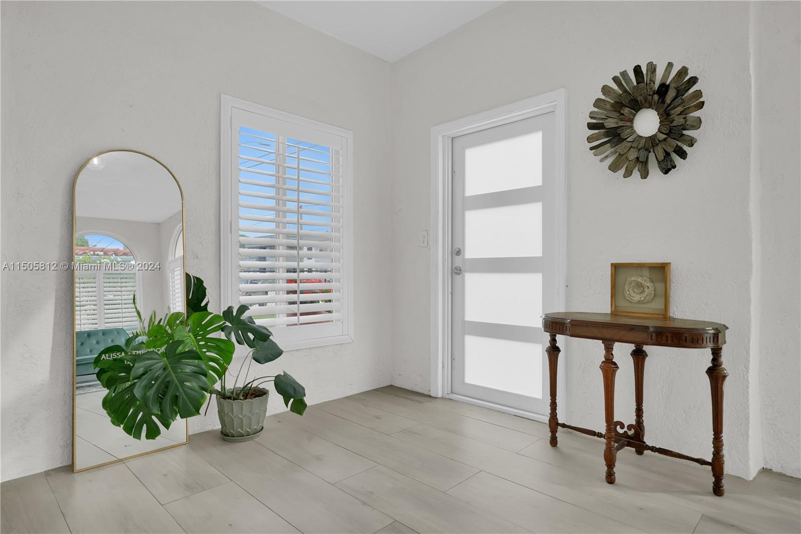 2043 Southwest 7th Street Miami, FL 33135 - Photo 6 of 37 a view of a room with a window and a potted plant