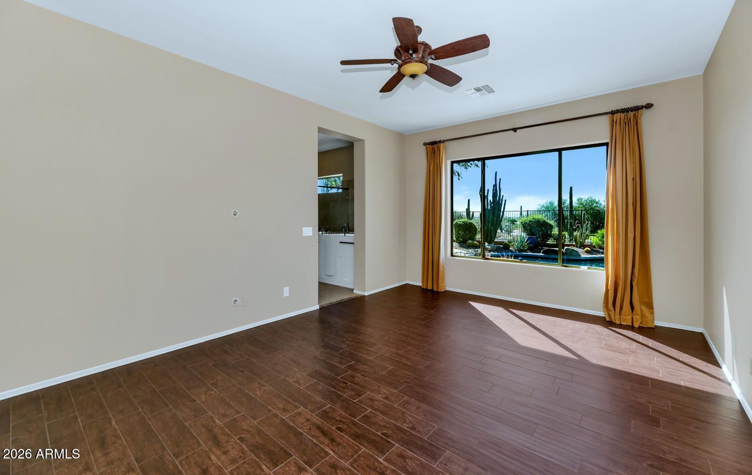 41123 North River Bend Road Phoenix, AZ 85086 - Photo 18 of 45 a view of empty room with wooden floor and fan