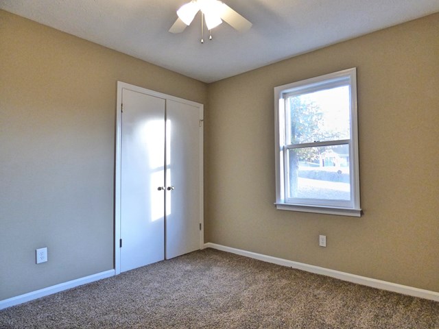 20 Ford Road Phenix City, AL 36869 - Photo 9 of 15 an empty room with a window and a chandelier fan