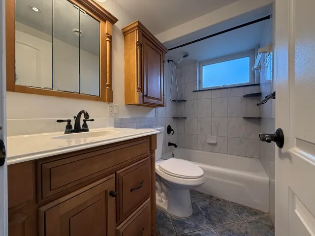 a bathroom with a sink a toilet and bathtub