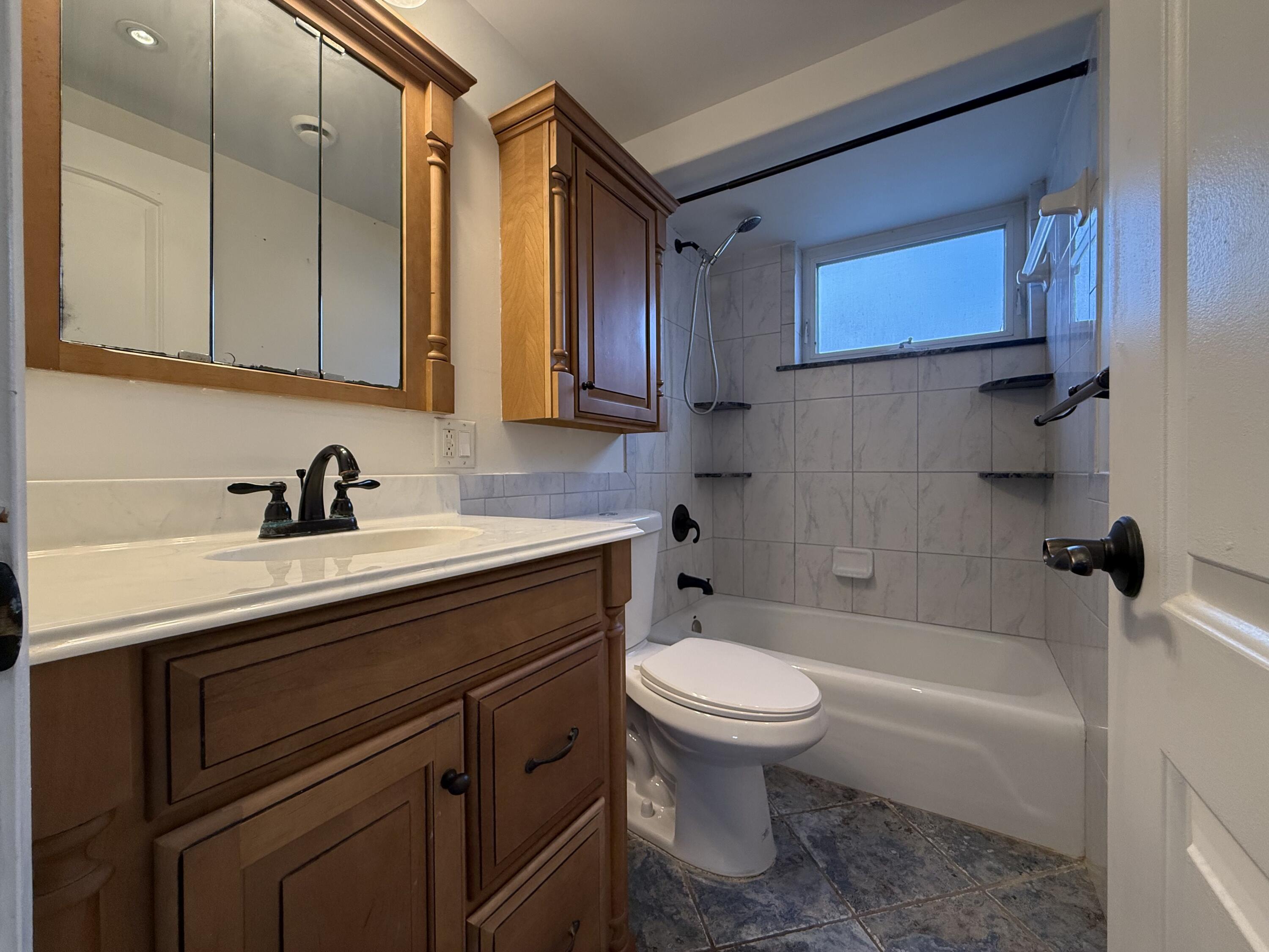 500 Southwest 15th Street, Unit 109 Pompano Beach, FL 33060 - Photo 11 of 17 a bathroom with a sink a toilet and bathtub