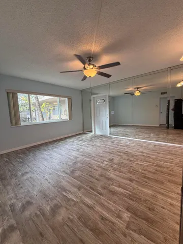 a view of a livingroom with a ceiling fan and window
