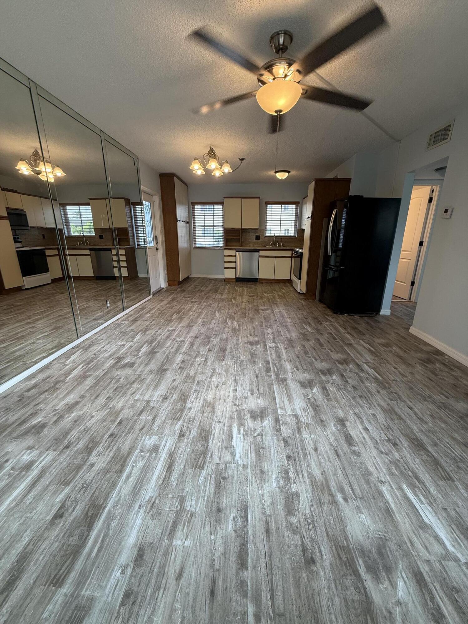 500 Southwest 15th Street, Unit 109 Pompano Beach, FL 33060 - Photo 15 of 17 a view of an empty room with a kitchen