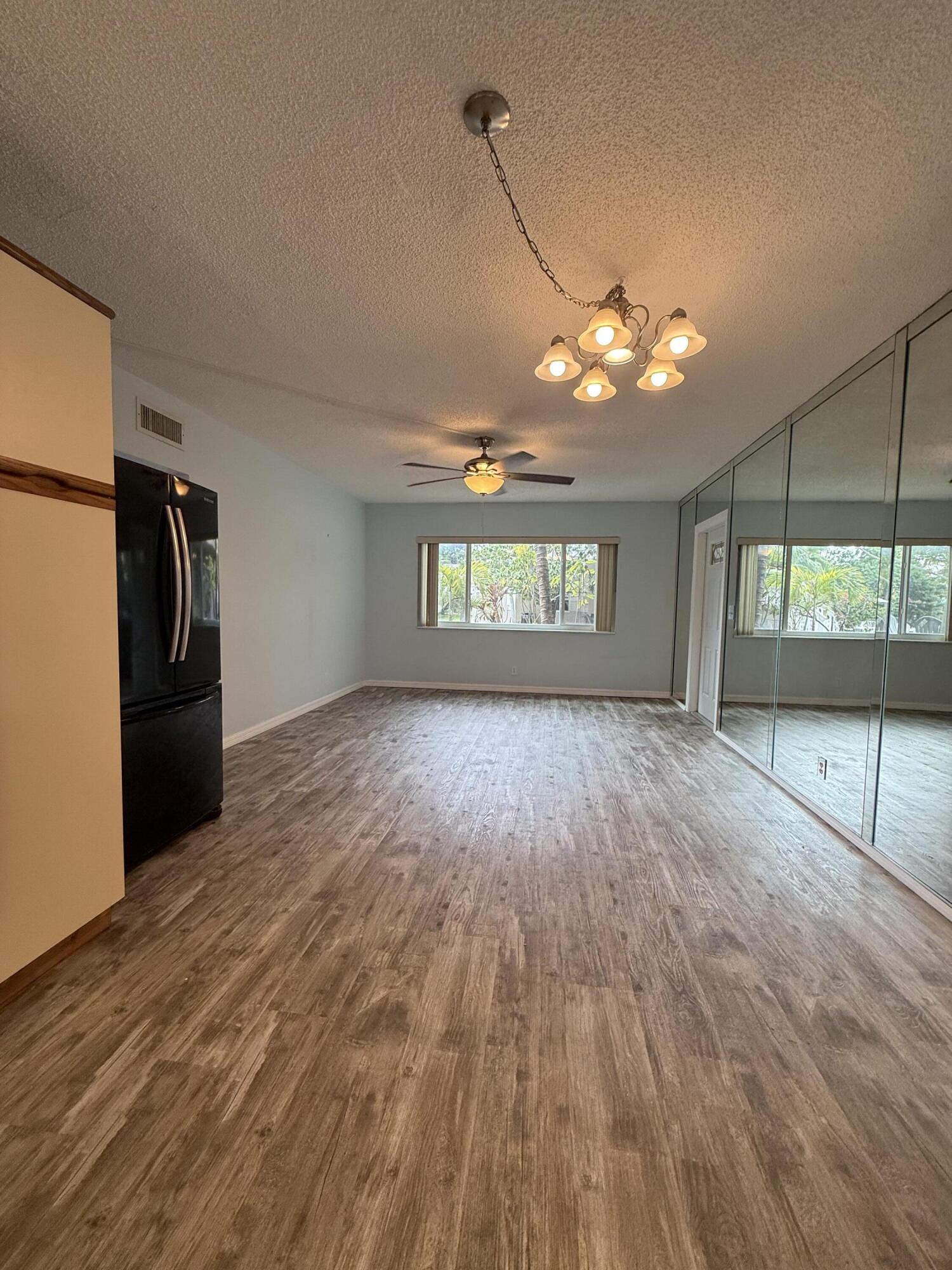 500 Southwest 15th Street, Unit 109 Pompano Beach, FL 33060 - Photo 16 of 17 a view of a room window wooden floor and front door