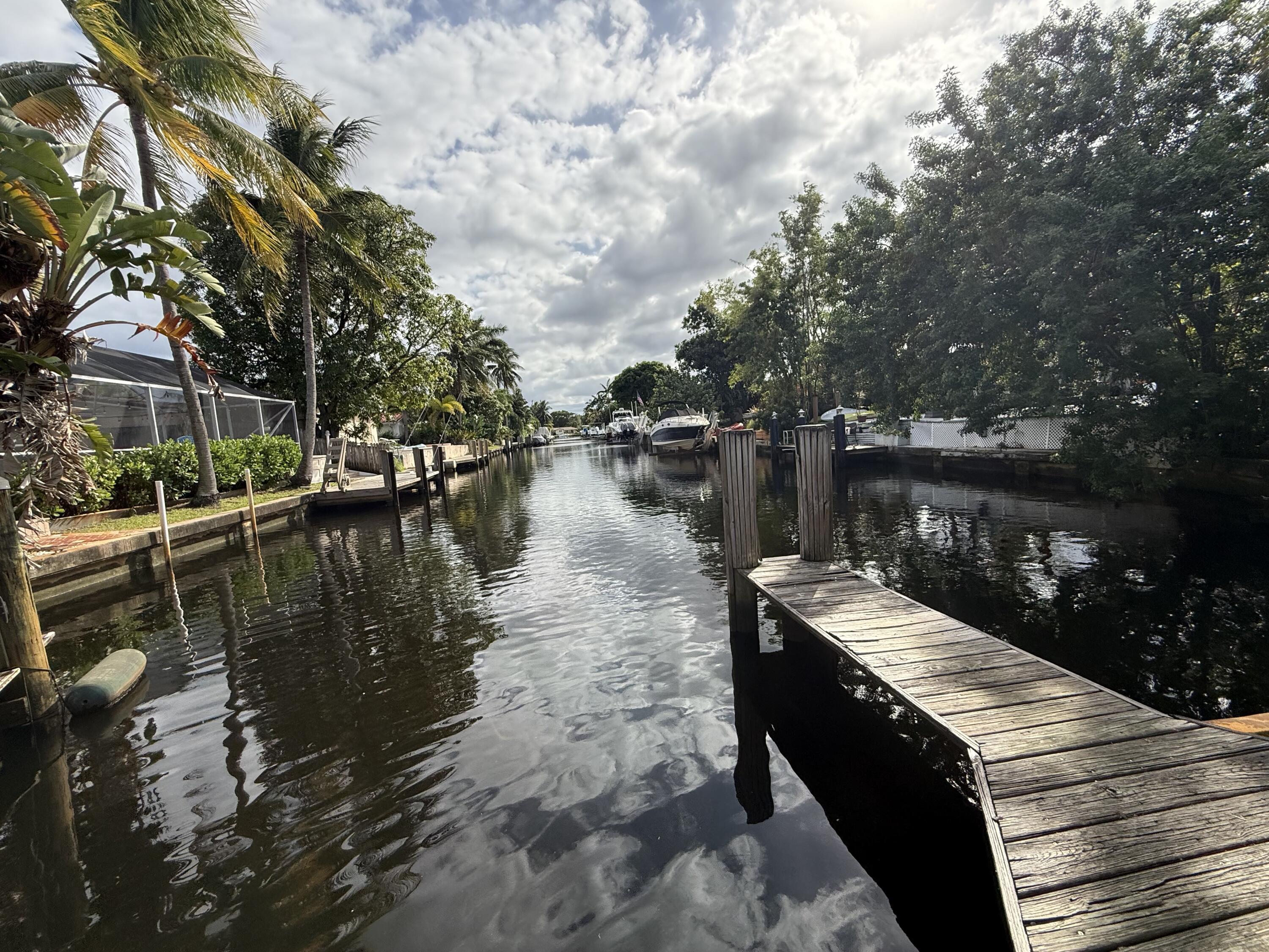 500 Southwest 15th Street, Unit 109 Pompano Beach, FL 33060 - Photo 4 of 17 a wooden pier with boats in a lake
