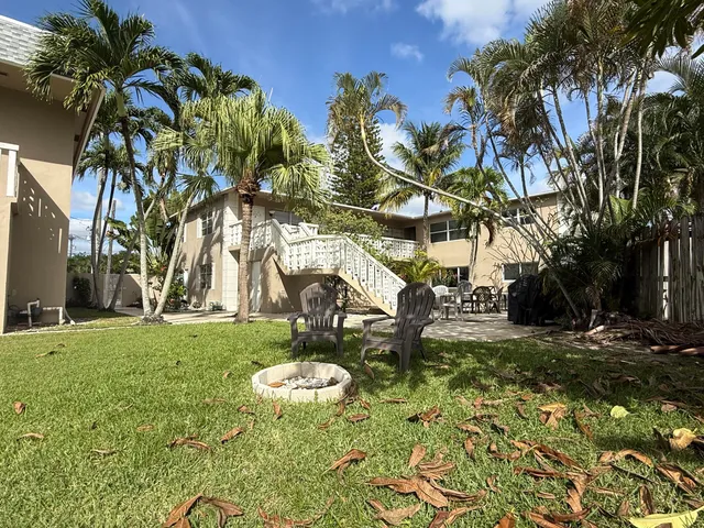a backyard of a house with table and chairs