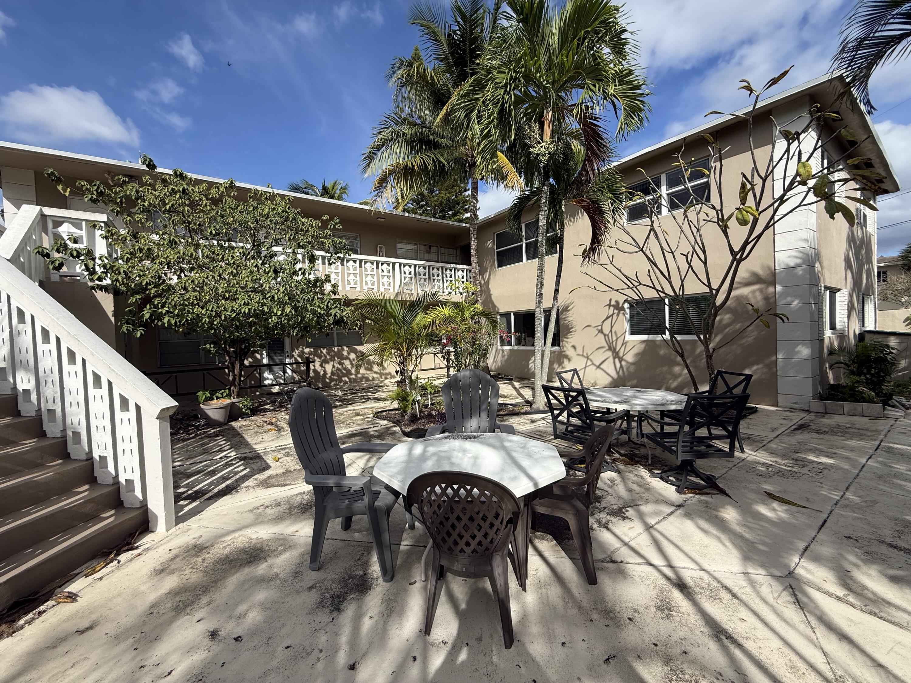 500 Southwest 15th Street, Unit 109 Pompano Beach, FL 33060 - Photo 6 of 17 a view of a patio with table and chairs with wooden floor and fence