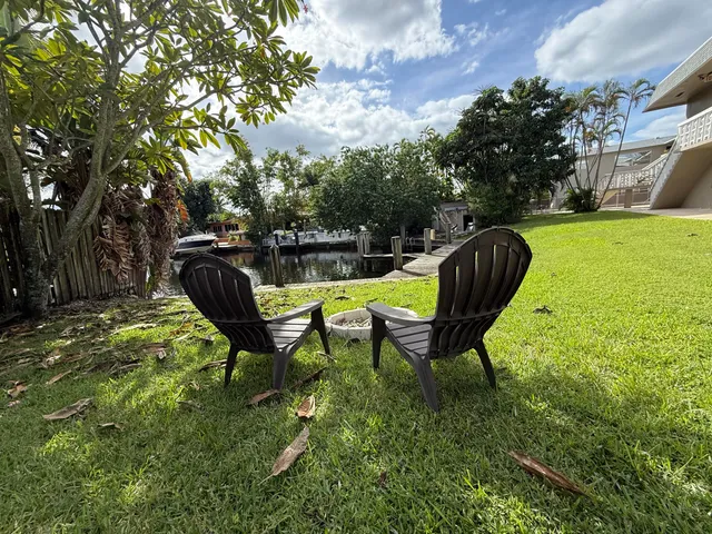a view of a backyard with table and chairs and a fire pit