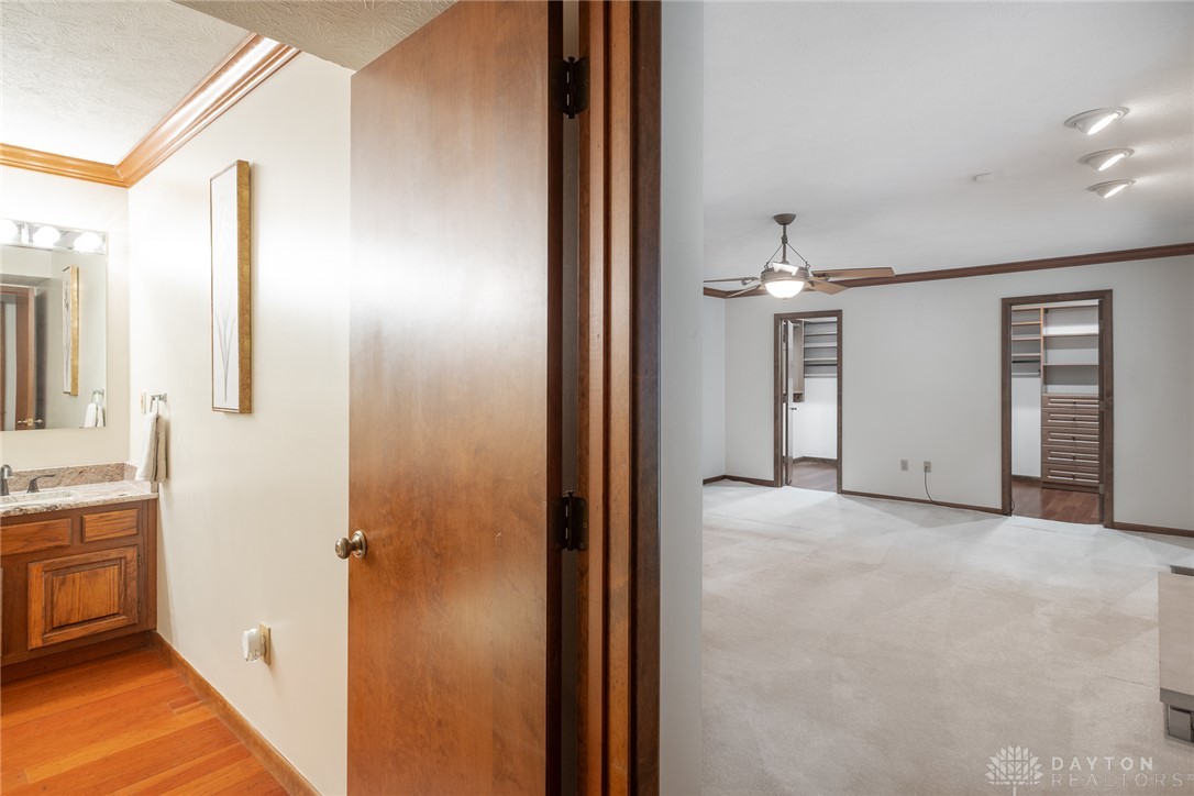 273 North Alpha Bellbrook Road Dayton, OH 45434 - Photo 21 of 43 This interior image showcases a spacious room with elegant flooring and convenient access to a well-appointed bathroom.