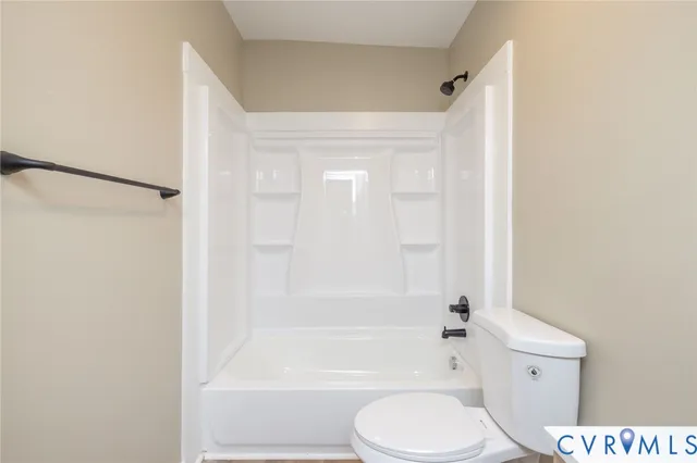 a bathroom with a toilet and a bathtub
