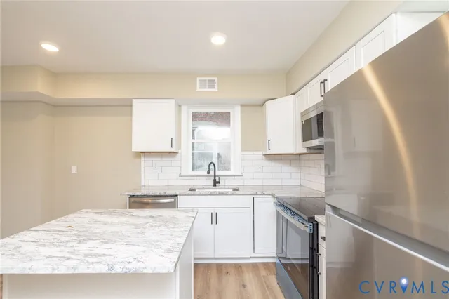 a kitchen with a sink stove and cabinets