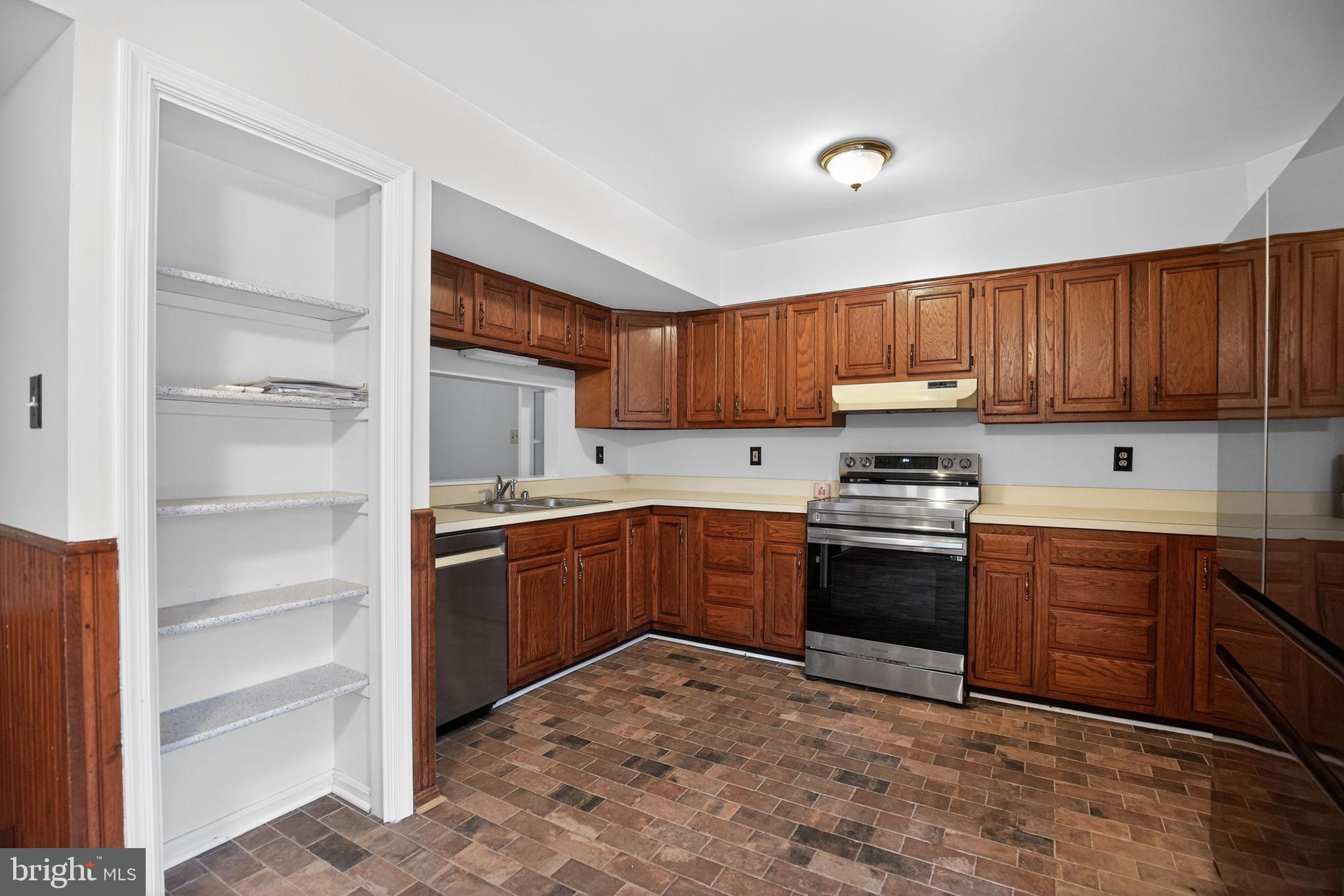 43447 Drum Cliff Road Hollywood, MD 20636 - Photo 16 of 37 Inviting kitchen with rich wood cabinetry.