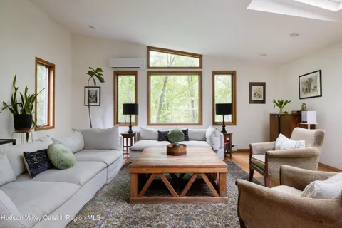a living room with furniture and large windows