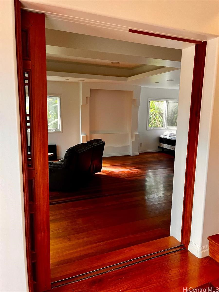 59-530 Hoalike Road Haleiwa, HI 96712 - Photo 17 of 25 a view of a hallway to room with wooden floor and windows