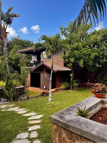 a view of a house with backyard and sitting area