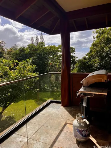 a view of balcony with chair and table