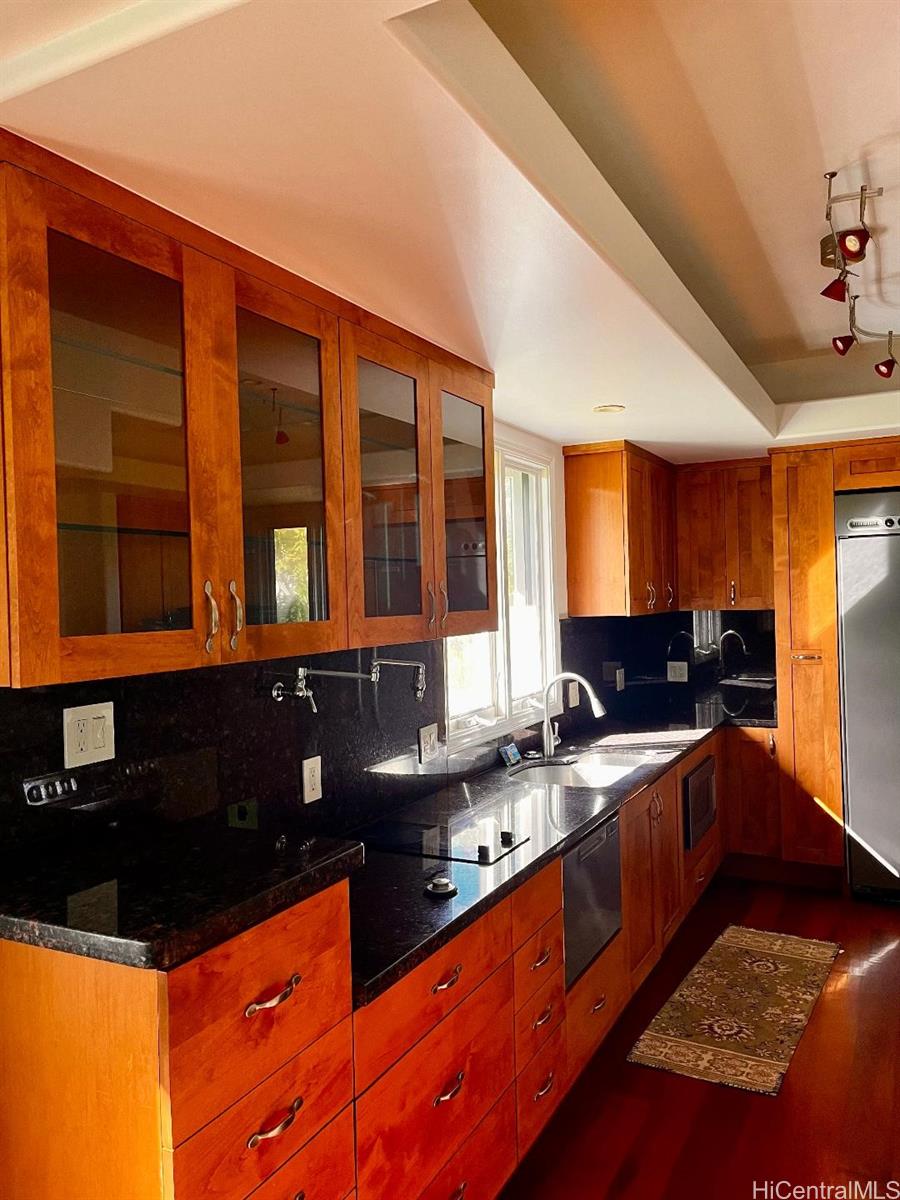 59-530 Hoalike Road Haleiwa, HI 96712 - Photo 4 of 25 a kitchen with granite countertop a sink and a stove top oven