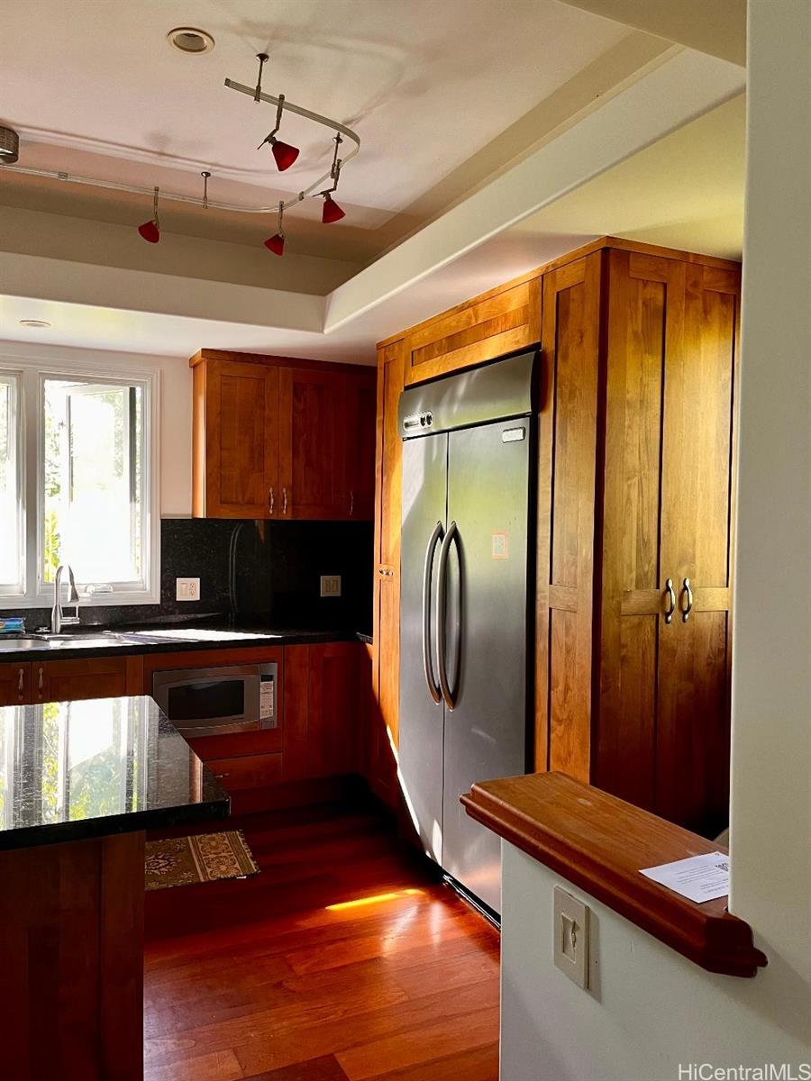 59-530 Hoalike Road Haleiwa, HI 96712 - Photo 5 of 25 a kitchen with stainless steel appliances granite countertop a stove a refrigerator and a microwave