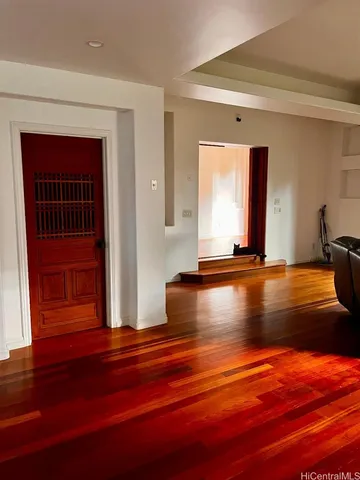 a view of room with window and wooden floor
