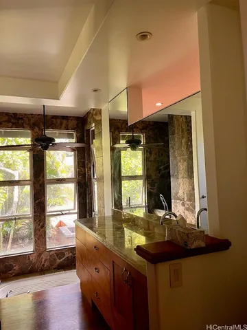 a bathroom with sinks a large window and a bathtub