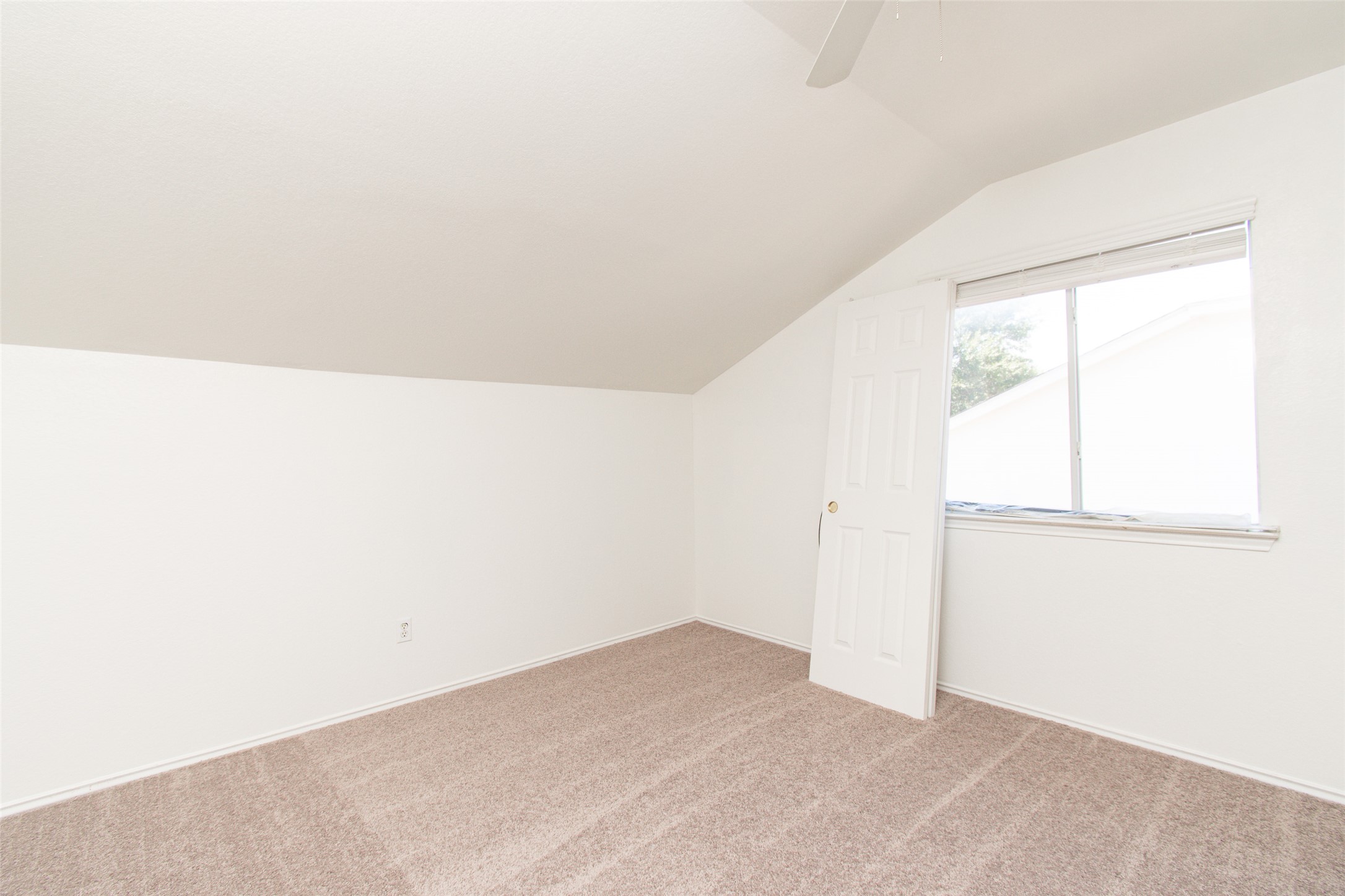 1436 Roxanne's Run Pflugerville, TX 78660 - Photo 17 of 24 Slanted ceilings and soft carpeting define this upper-level room with a large window.