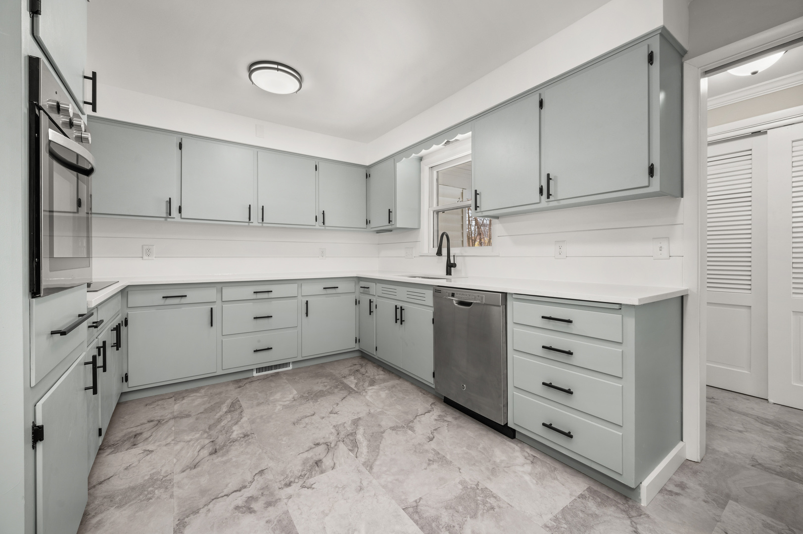 804 Normal Road DeKalb, IL 60115 - Photo 12 of 27 a kitchen with cabinets stainless steel appliances and a window