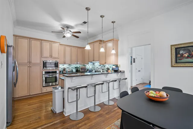 a kitchen with stainless steel appliances granite countertop a sink a stove and refrigerator