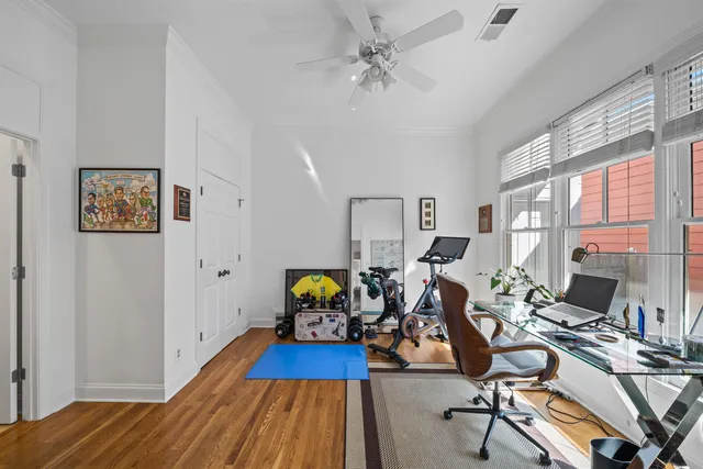 a view of a livingroom with workspace and a window