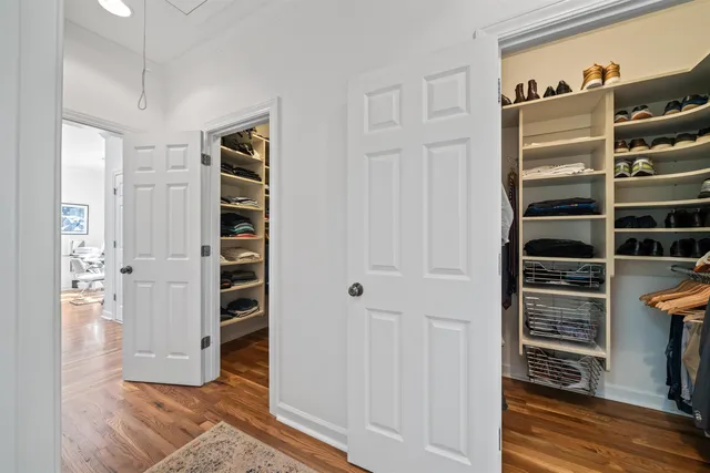 a view of walk in closet with clothes and shoes